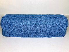 a blue bench cushion sitting on top of a white floor