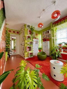 a living room filled with lots of plants and decor on top of red rugs