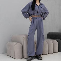 Women's tracksuit with trendy cargo pants featuring patch pockets. The pants have an adjustable drawstring at the bottom, allowing them to be worn as joggers. They feature a high-rise fit with an elastic waistband. The set includes a cropped zip-up jacket with adjustable drawstrings at the hem, enabling length customization. The jacket has a double-layered hood, patch pockets with flaps at chest level, and elastic cuffs. Material: Three-thread without fleece Colors: Black, white, khaki, and gray Trendy Cargo Pants, Women's Tracksuit, Blue Tracksuit, Activewear For Women, Cropped Zip Up, Hip Ups, Tracksuit Set, Tracksuit Women, Zip Up