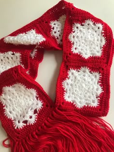 a red and white scarf is laying on the table