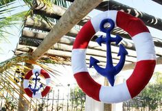 an anchor and life preserver hanging from a tree