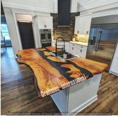 a kitchen counter made out of wood and white cabinets