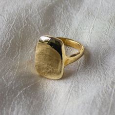 Dea Dia | Ingot Ring We love this signet ring for the soft, curved lines but strong, bold shape. The irregularity of this heavy ring harkens back to an ancient past. A thick gold ring that is a weighty and substantial piece of jewelry that will last a lifetime. Our number one bestseller, this beautiful big gold ring is created in recycled metals. Details: This modern, organic ring was first created by hand in wax Available in recycled brass or sterling silver, please read brass ring care and cleaning guides before ordering Sizes 6-9 kept in stock, inquire for custom sizing Silver Ingot Ring is made to order, please allow 1-2 weeks to ship Read jewelry care instructions below Made to order, final sale Handmade in Downtown Los Angeles. Open Rings Design, Bold Gold Rings, Brass Rings Handmade, Big Gold Ring, Brass Rings Jewelry, Thick Gold Ring, Silver Ingot, Brass Rings, Organic Rings