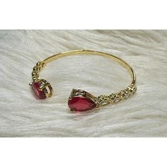 This Merry Bracelet Cuff-red is a high-quality accessory crafted with 18 karat gold plating and triple-coated for durability. The gold-plating provides an eye-catching finish to the sleek design, ensuring it is the statement piece of any wardrobe. Gold Ruby Bangle, Elegant Red Bangle Gold Bracelet, Elegant Red Gold Bangle Bracelet, Red Ruby Bangle As Gift, Elegant Gold Bangle With Ruby, Elegant Red Bangle For Formal Occasions, Red Metal Bangle For Party, Elegant Red Bangle Bracelets, Elegant Red Metal Cuff Bracelet