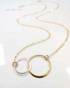 Infinity Linked Eternity Necklace - Gold Bronze & Silver Mixed MetalA dainty circle necklace to represent the two of you. Simple and pretty, it goes with everything!........................ Bronze & sterling silver mixed metal hoops are polished to shine. Made with a shimmery 14k gold filled or sterling silver chain. Length of attached hoops are 27mm combined. (about 1 Inch) Total necklace length is shown at 18" (Model has size small neck) Necklace closes with a 14k gold filled or sterling silve Neck Necklace, Infinity Necklace Gold, Mixed Metal Necklace, Eternity Necklace, Metal Necklace, Infinity Necklace, Circle Necklace, Circle Pendant, Mixed Metals