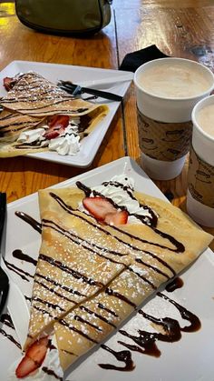 there is a plate with pancakes and ice cream on it, along with two cups of coffee