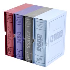 three books are stacked on top of each other in different colors and sizes, with the covers folded down