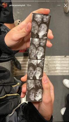 a person holding up a card with photos on it