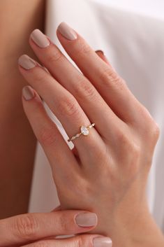 a woman's hand with a ring on it