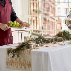 a woman in an apron serving food on a tray