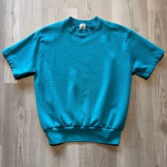 Vintage 90's Fruit Of the Loom Teal Blue Blank Sweatshirt Short Sleeve Tee Shirt Medium M Crewneck Pullover.  20x24 In very good overall condition. See photos for extra details. Feel free to message me if you have any questions! Blank Sweatshirts, Sweatshirt Short Sleeve, The Loom, Fruit Of The Loom, Teal Blue, Short Sleeve Shirt, Loom, Mens Sweatshirts, Vintage 90s