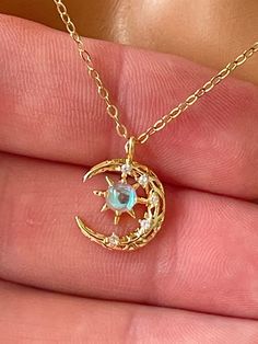 This is a darling 14 karat gold filled moon and star charm necklace. This lovely charm features a lab created opal along with pave crystals set in 14 K gold-filled.  Such a beautiful dainty charm that measures 15x11mm and comes on a shiny cable chain with spring clasp and back.  Model is wearing a 16 inch length. Entire necklace is 14K gold filled.Please choose your desired length and the drop-down list. Comes in a gift box ready to present. Dainty Gold Moonstone Jewelry, Celestial Moon Charm Jewelry As Gift For Her, Crescent Moonstone Gold Jewelry, Delicate Moon Shaped Jewelry For Gift, Delicate Moon-shaped Jewelry Gift, Celestial Birthstone Necklaces, Celestial Gold Necklace With Moonstone, Gold Moonstone Necklace As Gift, Gold Moonstone Necklace For Gift