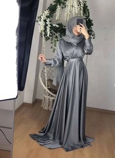 Exclusive modest gown crafted in premium Satin silk for quality & durability.It features a tie neckline for elegance,concealed& back zipper closure.fit & flare silhouette This beautiful gown wont disappoint. Model is wearing S in Grey.Hijab will not be matching as the materials will be different!Final sales No exchanges No refunds. In case of a defect, please make an open parcel video! *No claim will be entertained without an open parcel video!** Ivory white maybe see through match it with our s Wedding Dresses For Eid, Fitted Maxi Dress For Eid And Formal Occasions, Eid Wedding Solid Color Abaya, Elegant Solid Color Dresses For Eid, Elegant Eid Maxi Dress, Fitted Maxi Dress For Eid, Elegant Solid Color Wedding Abaya, Elegant Satin Gown For Eid, Satin Floor-length Abaya For Eid