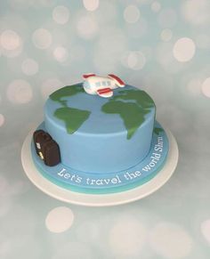 there is a cake that has a plane on it and the words let's travel this world