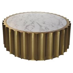 a white marble topped table with gold trimmings on the top and bottom, sitting in front of a white background