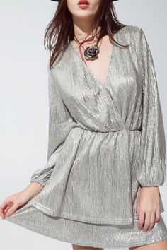 Introducing our Glamorous Silver Wrap Long Sleeve Tiered Dress – a stunning piece that combines elegance with a touch of festive sparkle, ideal for your New Year's celebration or any special event. Dazzling Metallic Silver Fabric: This dress is crafted from 100% Polyester with a metallic silver finish, ensuring you stand out with a luxurious shimmer. Flattering Wrap Front Design: The wrap front not only flatters your figure but also adds a touch of timeless elegance to the overall design. Chic T Silver Mini Dress, New Years Look, Boutique Wholesale, Tiered Mini Skirt, Red Plaid Flannel, Silver Fabric, Style Party, New Clothes, Silver Dress