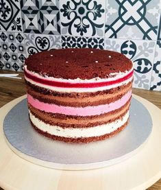 there is a cake that has been decorated with red, white and pink frosting