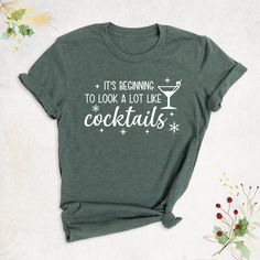 "Christmas Drinking Shirt, It's Beginning to Look a Lot Like Cocktails Shirt, Christmas Party Shirt, Holiday Xmas Shirt, Funny Christmas Shirt Hello, Thanks for your support. Your gladness comes first and all work is done with LOVE in here. Always keep your support, please:) Christmas Drinking Shirts are branded Bella+Canvas. Christmas Drinking Shirt Contents: - Solid colors: %100 Cotton. - Heather colors: %52 Cotton + %48 Polyester* This ultra-soft graphic tee is made from a comfortable cotton- Christmas Funny Shirt Ideas, Christmas Drinking Shirts, Xmas Embroidery, Xmas Clothes, Christmas Cruise, Christmas Drinking, Christmas Party Shirt, Soft Graphic, Christmas T Shirt Design