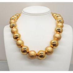 This is part of Chairish’s Costume Jewelry assortment.  Goldtone large smooth and "hammered" goldtone bead single strand necklace with hook clasp. Marked "Napier" on the hook. Dates to 1992. Interior circumference about 20 1/4 inches at the largest setting. Beads are 3/4 inches across. Overall measures: 8 inches long by 5 3/4 inches wide. Condition: Very good; light surface wear to some of the beads. The matching charm bracelet (which I'm also selling) is shown on pg. 685 of Melinda L. Lewis & H Classic Gold Necklace With Faceted Beads, Gold Single Strand Beaded Necklace For Costume Jewelry, Gold Single Strand Beaded Costume Necklace, Gold Necklaces With Large Beads For Formal Occasions, Formal Gold Necklaces With Large Beads, Formal Gold Necklaces With Faceted Beads, Formal Gold Necklace With Large Beads, Formal Gold Beaded Necklace With Faceted Beads, Gold Jewelry With Faceted Beads For Formal Occasions