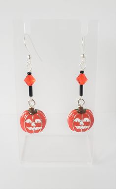 You will receive one pair of Pumpkin Charm Earrings. The charm is silver plated  and enamel jack o lantern. The beads are small hyacinth glass beads.  The earring is silver plated.  The length of the earring is about 1.50 inches. Thank you for looking Hypoallergenic Drop Earrings For Halloween, Nickel-free Novelty Drop Earrings, Dangle Earrings As Halloween Gift, Dangle Earrings For Halloween Gift, Handmade Sterling Silver Halloween Earrings, Silver Ear Wire Earrings For Halloween, Hypoallergenic Dangle Earrings For Halloween, Halloween Teardrop Jewelry Gift, Halloween Sterling Silver Dangle Earrings