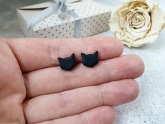 "These cute cat shaped studs are great for everyday wear. Simple and minimalist earrings for every cat lover out there. They can also be a great gift as they are displayed on beautiful earrings card with a quote: \"Love is a four legged word\". ➤LISTING INCLUDES: ➣ One PAIR of stud earrings ➣ Color: black, white or silver (choose from drop-down menu) ➣ Size: 10 mm ( approx. 0.4 inches). ➤MATERIAL: ☑ polymer clay ☑ Surgical steel or titanium posts (choose from a drop-down menu) ■ ■ We have combin Cute Black Cat Design Earrings, Cat Design Earrings With Cat Ears, Cute Black Earrings For Gifts, Cute Black Earrings For Gift, Cute Black Earrings For A Gift, Cat Design Earrings With Cat Ears For Gifts, Cute Black Earrings As A Gift, Cat Design Earrings With Cat Ears Shape For Gift, Black Cat Ears Jewelry With Cat Design