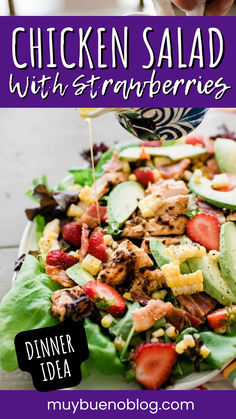 chicken salad with strawberries is being drizzled over it and served on a plate