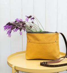 "The Marabara Day bag has been designed to accompany you every day. It is made of cotton canvas in a nice mustard colour. Don't be tricked by its small size, this bag is roomy enough to carry all your daily essentials (wallet, phone, notebook, sunglasses...) and it's light as a feather. You won't even notice you are carrying it, so comfortable that you will want to take it with you all the time. It closes with a metal zipper and comes with an adjustable leather strap, in chocolate colour. It is Yellow Canvas Shoulder Bag With Removable Pouch, Yellow Canvas Satchel Bag, Yellow Canvas Shoulder Bag For Daily Use, Yellow Canvas Shoulder Bag For Everyday, Everyday Yellow Canvas Shoulder Bag, Daily Use Yellow Canvas Shoulder Bag, Yellow Pouch Bucket Bag For Everyday, Yellow Bucket Bag With Adjustable Strap For Everyday, Yellow Everyday Bucket Bag With Adjustable Strap