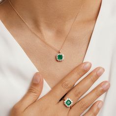 Dainty and feminine, our Emerald Princess Ring from the Envy collection is an instant icon. A dazzling emerald fusion stone ring serves as the focal point from a delicate masterfully crafted from hypoallergenic 925 sterling silver and plated in 14K gold. This timeless design is completed with the addition of round-cut cubic zirconia enveloping the emerald to make the vibrant green pop all the more. Metal: 925 Silver Plating: 14K Gold E-coated Size: 6-9 Adjustable Stone: Emerald Fusion Stone with Luxury Fine Jewelry Emerald Necklace, Emerald Pendant Design, Emerald Sets Jewellery, Emerald Gold Necklace, Emerald Jewelry Necklace, Emerald Chain, Galaxy Stuff, Emerald Pendant Necklace, Emerald Set