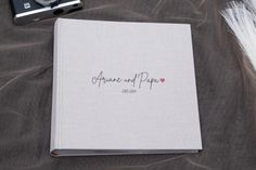 a wedding album with the word anana and papa written on it next to a camera