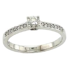 a white gold ring with a princess cut diamond