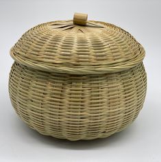 a wicker basket with lid is shown on a white background