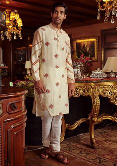 Editor's Note Featuring a long floral print bandgala kurta, styled with churidaar in chanderi base. Fabric: Chanderi Color: Cream Components: Kurta and pant Occasion: Festive Disclaimer: Product color may slightly vary due to photographic lighting sources or your monitor setting. Care: Dry Clean Only About the Designer Kalista is a luxury fashion label that specializes in designer clothing for millennial women. Founded by fashion designer turned entrepreneur, Pratyush Guglani, this indigenously Beige Kurta, Red Kurta, Kurta Set For Men, Mens Designer Fashion, Female Model, Churidar, Kurta Set, Designer Clothes For Men, Full Sleeves