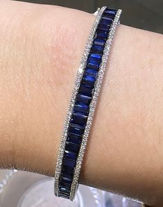 Bangles are great for stacking, but with this bold and beautiful blue sapphire & diamond bangle bracelet, you only need one!Metal: 18K White Gold Sapphire Weight: (33) 5.94ct twDiamond Shape , Weight: (134) Round Brilliant-cuts 0.50ct t.w.Bangle/Wrist Width: 57mm x 48cmBangle Weight: 8mm Expensive Bracelets, Emerald Bangles, Sapphire Bangle, Blue Sapphire Bracelet, White Gold Bangle, Diamond Bangle Bracelet, Award Ceremony, Ruby Bracelet, Jewelry Drawing