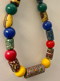 "This African trade bead necklace features 11 unique Venetian glass beads including Millefiori, French Cross, and other interesting patterns.   Each is spaced with a bright round resin/plastic bead, and then finished with a gold tone chain and fastens with a silver tone lobster clasp. Measures 18.25\"  The stringing material used is clear, and is visible where it attaches to the wire. There is no jumpring on the end of the chain, the lobster clasp attaches into the chain. Excellent vintage condi Interesting Patterns, Glass Beads Jewelry, African Trade Beads, Jewelry Chain, Venetian Glass, Trade Beads, Plastic Beads, Beads Jewelry, Bead Necklace