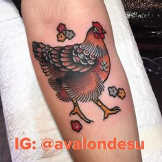 a tattoo with a rooster on it's arm