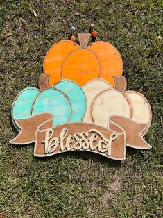 a wooden sign that says blessing on it in front of some pumpkins and leaves