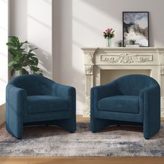 two blue chairs sitting next to each other on top of a rug in front of a fireplace