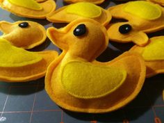 there are many felt ducks on the table