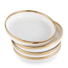 three white and gold plates stacked on top of each other