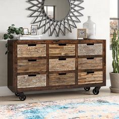 a dresser with drawers and a mirror on top of it next to a potted plant