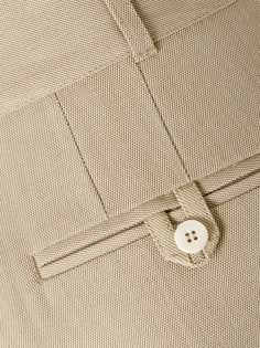 a button is attached to the side of a dress shirt that has buttons on it