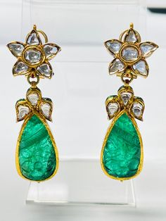 These gorgeous and one of a kind carved and diamond earrings are beautifully handmade in yellow gold.  The details are as follows :  Emerald weight : 50 carats approximately   Diamond weight : 2.50 carats  Gold : yellow gold  Gross weight : 38.16 grams Luxury Carved Earrings For Formal Occasions, Luxury Carved Earrings, Luxury Green Pierced Earrings, Elegant Carved Earrings For Formal Occasions, Green Luxury Pierced Earrings, Green Luxury Earrings, Carved Diamond Fine Jewelry, Fine Carved Diamond Jewelry, Luxury Bridal Rose Cut Diamond Drop Earrings