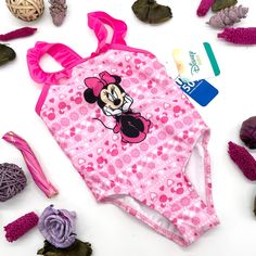 Disney Minnie Mouse Baby Girl One-Piece Ruffle Swimsuit Size 24m Your Little One Will Absolutely Love This Adorable Minnie Mouse One Piece Swimsuit. This Officially Licensed Bathing Suit Features An All Over Repeat Pattern With Fun Icons, A Large Printed Minnie Smiling And Ruffle Shoulders Complete This Piece For Your Next Beach Day. Officially Licensed Bathing Suit Upf+ 50 Ruffles Fitted Pink Bodysuit With Cartoon Print, Pink Character Print Onesie For Playtime, Pink Playful Onesie With Character Print, Playful Pink Onesie With Character Print, Pink Cartoon Print Bodysuit For Summer, Summer Pink Bodysuit With Cartoon Print, Cute Pink Onesie With Character Print, Cute Pink Swimwear With Character Print, Playful Pink Character Print Swimwear