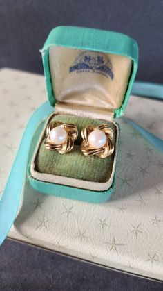 These are a very pretty pair of vintage faux pearl gold tone metal clip-on earrings. Unsigned. A few light surface scratches found throughout. Some patina found on backs. Please see photos. Sold as is. Priced accordingly. Will be packaged in a gift box perfect for giving. Some pictures are enlarged to show detail. Does not include any props in photos. Please feel free to contact me with any questions you may have. Before you buy, please note that the items in my shop are pre-owned and may (or ma Milwaukee Wi, Some Pictures, Gold Tone Metal, Clip On Earrings, See Photo, Faux Pearl, Etsy Earrings, Patina, I Shop