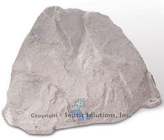 a large rock sitting on top of a white floor next to a sign that says copyright smith solutions, inc