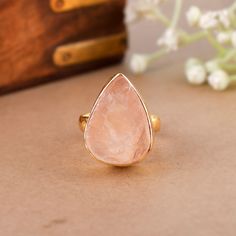 Raw Rose Quartz Ring, Pear Shape Ring, Adjustable Ring, Love Stone Ring, Heart Chakra Ring, Pink Quartz Ring, Everyday Wear Ring, Gift For Her Product Detail SKU: DJR-1808 Weight : 8.00 Gms Stone : Rose Quartz Ring Size: 4-11 US Stone Size: 13*18mm Stone Shape: Pear Metal: Brass{Gold Plated} Please Note: Color in the picture may be slightly different from the actual product, because these are natural Gemstone and may slightly differ from the photograph and light conditions. We tried to describe Raw Rose Quartz Ring, Pink Quartz Ring, Chakra Ring, Pear Shape Ring, Ring Everyday, Pear Shaped Ring, Raw Rose Quartz, Ring Heart, Rose Quartz Ring