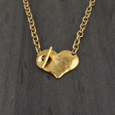 "Hammered gold heart pendant with front toggle on gold link chain. - Gold plated pewter pendant and chain - High quality plating that maintains original luster for years - Heart measures 1.5 x 1.25\" - 18 or 16\" length - choose in options Here is the link to the matching bracelet: https://mosaicsunstudio.etsy.com/listing/1621285707" Metal Heart Toggle Necklace With Heart Charm, Metal Toggle Necklace With Heart Charm, Vintage Gold Heart Necklace With Lobster Clasp, Elegant Heart Necklace With Toggle Clasp, Elegant Gold Toggle Necklace For Valentine's Day, Gold Heart Necklace For Everyday, Everyday Gold Heart Necklace, Metal Necklaces With Heart Pendant And Toggle Clasp, Metal Heart Pendant Necklace With Toggle Clasp