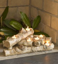 a group of candles sitting on top of logs