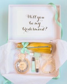 the bridesmaid gift box is filled with personalized items