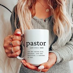 a woman holding a white coffee mug with the word jesus bridesmaid on it